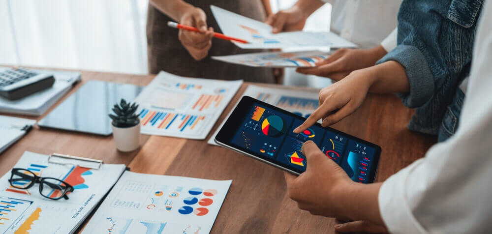 two people looking at a tablet to determine progress