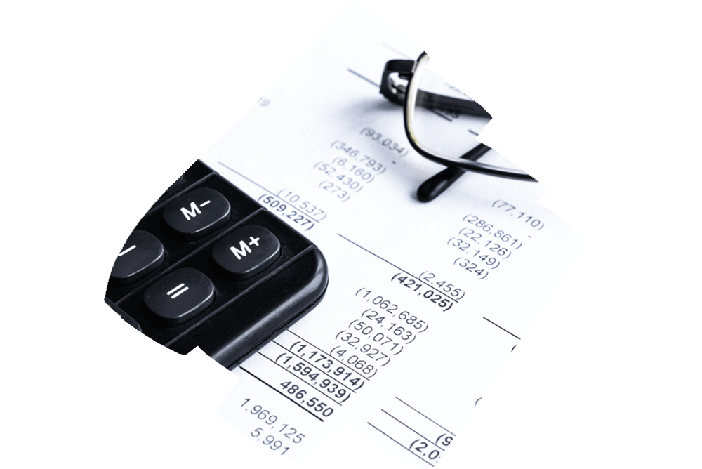 A close-up image of a financial report with rows and columns of numbers indicating expenses and cash flow. A calculator and a pair of glasses are placed on top of the document, suggesting active analysis or review.