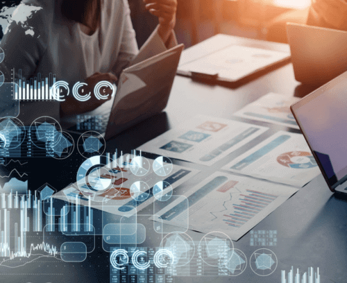 The image displays a professional setting with individuals engaged in financial analysis. There are laptops, documents, and digital graphs overlaying the scene, symbolizing advanced financial strategies and data analysis. The digital elements suggest a focus on hedging strategies and risk management in a business environment.