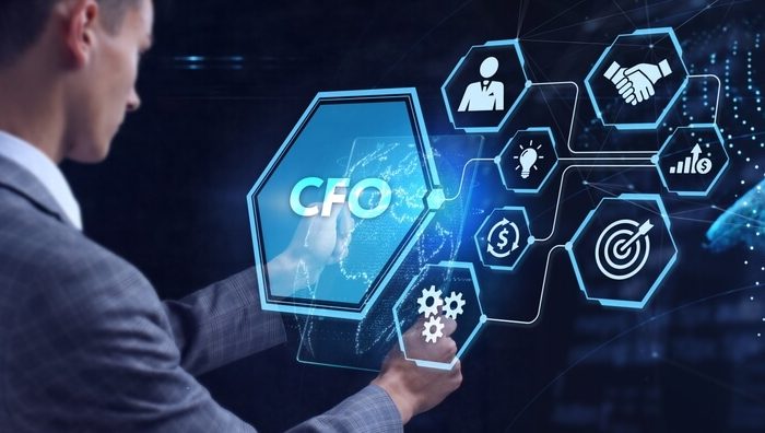 The image shows a person interacting with a virtual interface displaying various icons related to financial management, including a hexagon labeled "CFO." This represents the role of a Fractional CFO, a senior financial professional who provides expert financial leadership on a part-time or project basis. The interface highlights tasks such as cash flow management, budgeting, and strategic planning, emphasizing the importance of a Fractional CFO in offering strategic oversight without the need for a full-time commitment. This flexible arrangement helps businesses optimize costs and resources while navigating financial complexities.