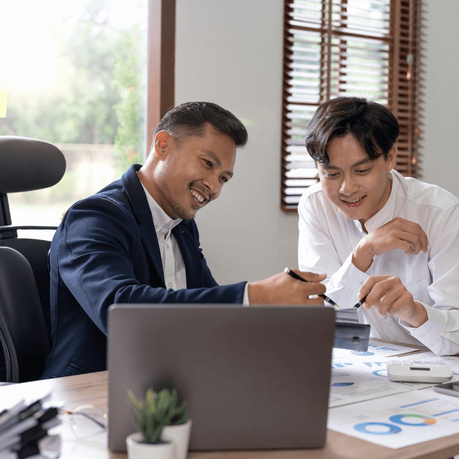 Professionals reviewing a financial chart and data on a laptop, showcasing expertise in Financial Planning and Analysis.