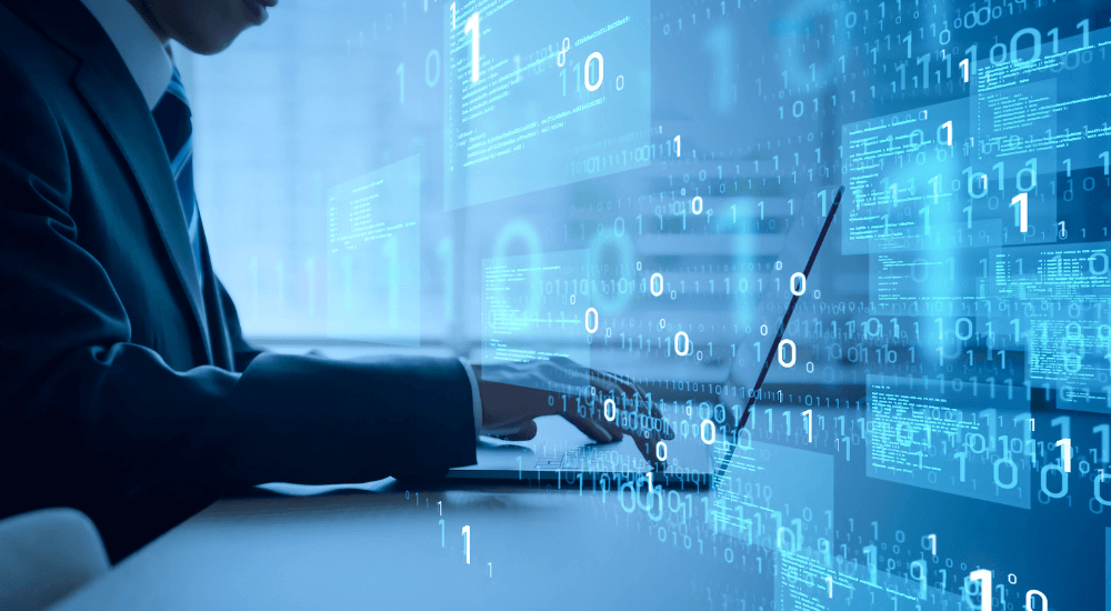 A professional working on a laptop with binary code graphics, representing ARK9 EIR IFRS 9 compliance software's unified data view.