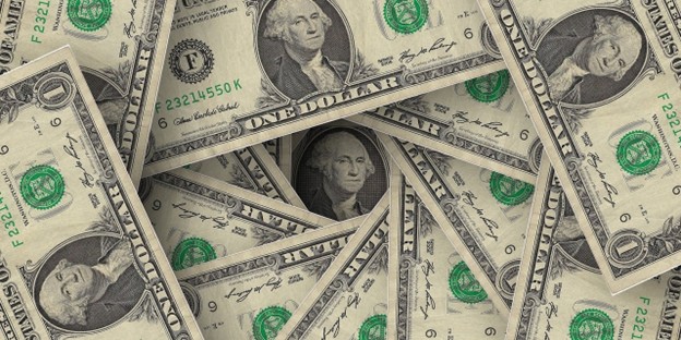 Close-up of multiple one-dollar bills emphasizing fair value measurement under IFRS 2