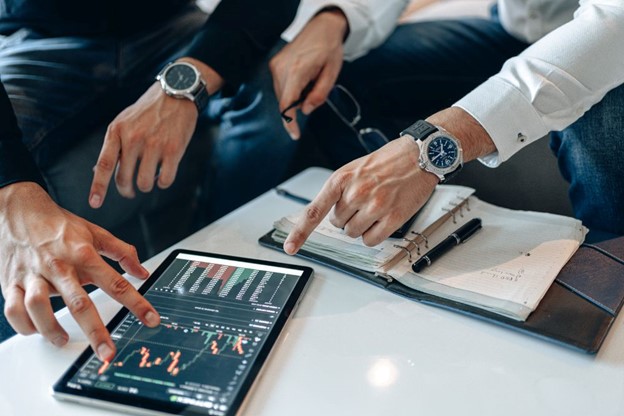 Two professionals analyzing financial data on a tablet, showcasing the use of technology in IFRS 17 compliance and reporting.